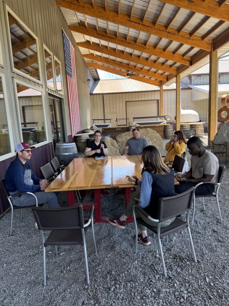 Wine grape growers conversing with research team members.