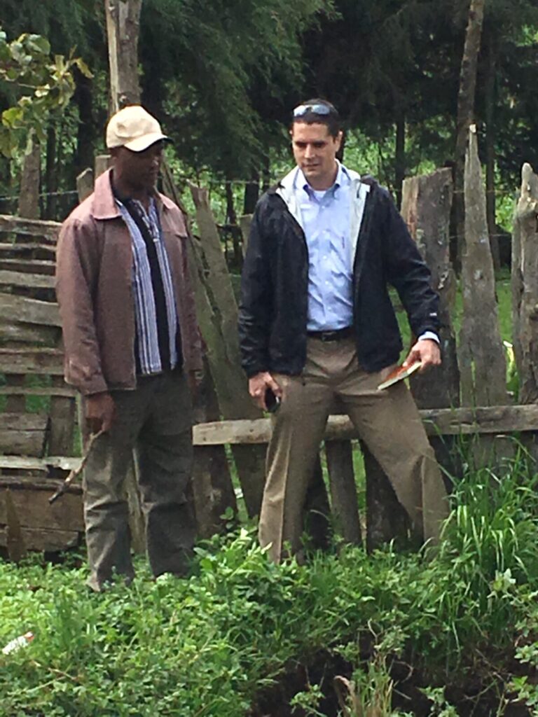 Farmer explaining sustainability practices to a scientist in Kenya.