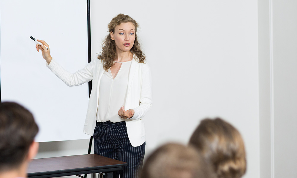 A woman engaging others in a class