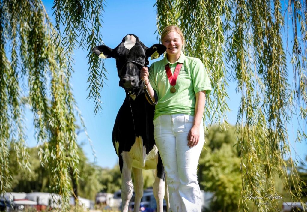 Megan Meyers poses for a picture with one of her cows