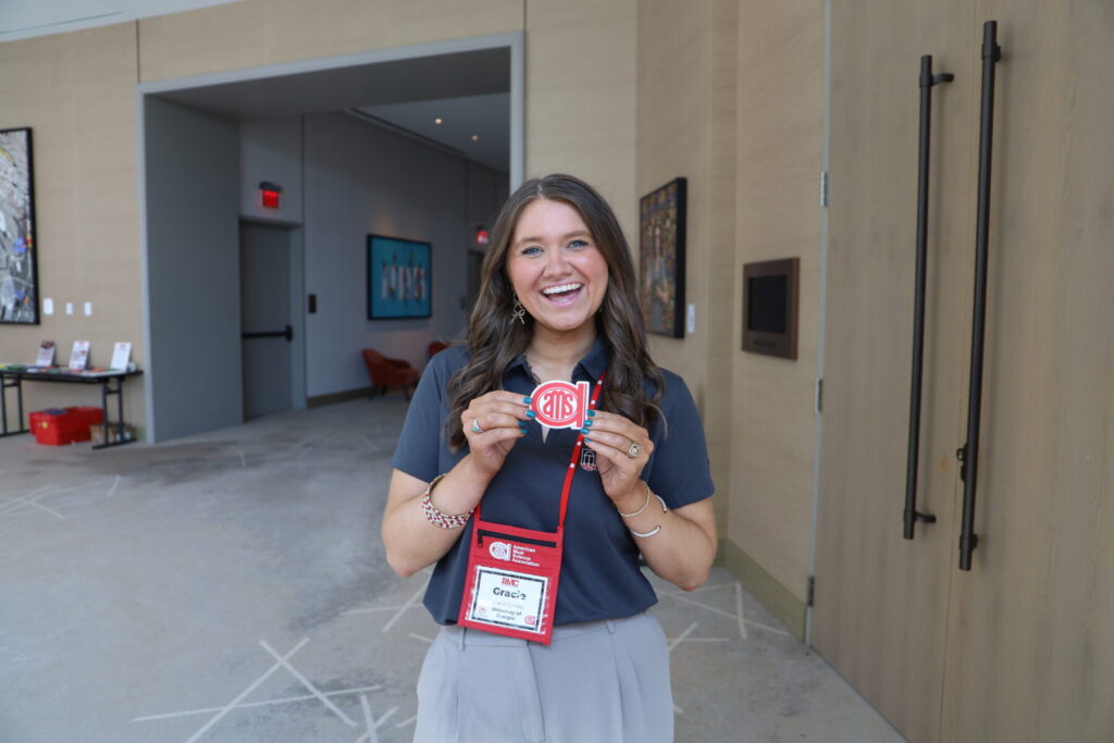 Gracey poses for a photo with the AMSA logo at the Ohio conference