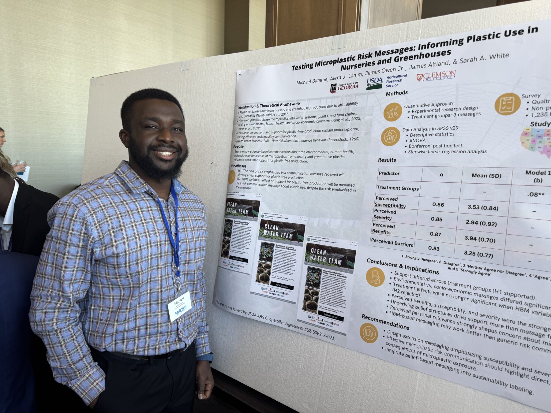 Michael presenting his poster at NACS 2026