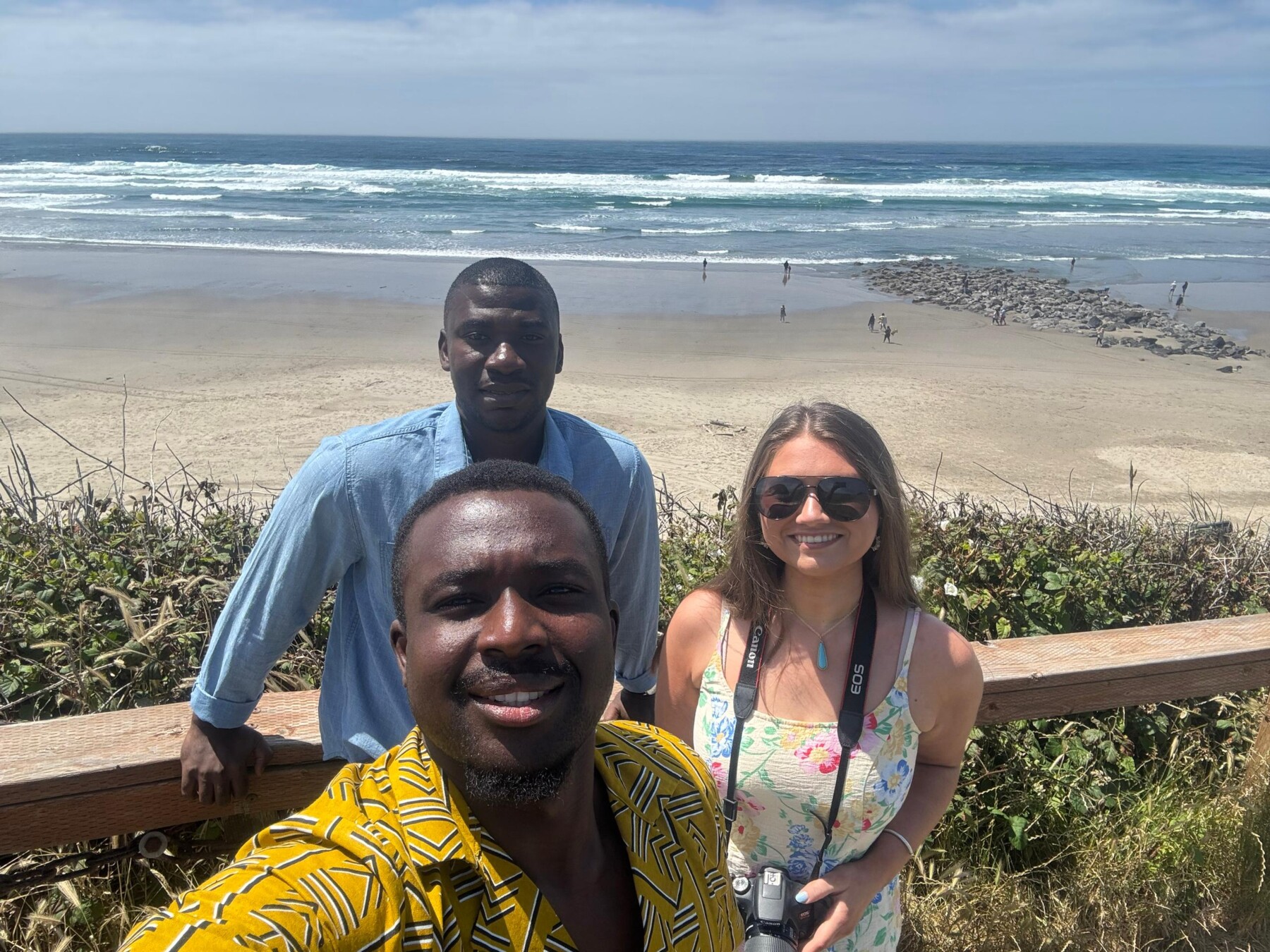 Dennis, Michael, and Gracie pose for a picture in front of the Pacific Ocean at Newport, Oregon.