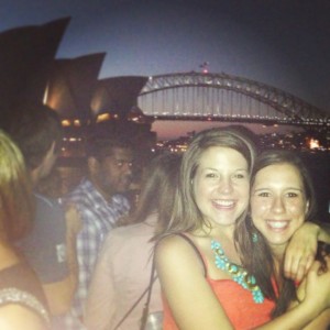 On a dinner cruise around the harbor with the Opera House and bridge in the background with a fellow UGA friend.